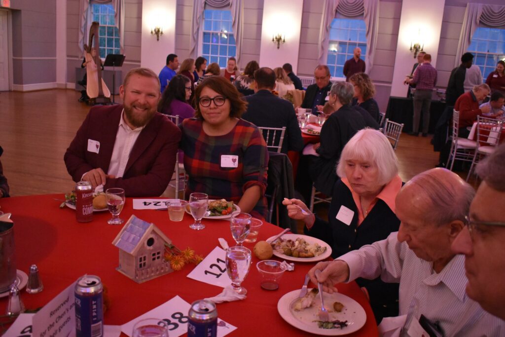 L'Arche supporters at the Heart of L'Arche benefit eating their dinner