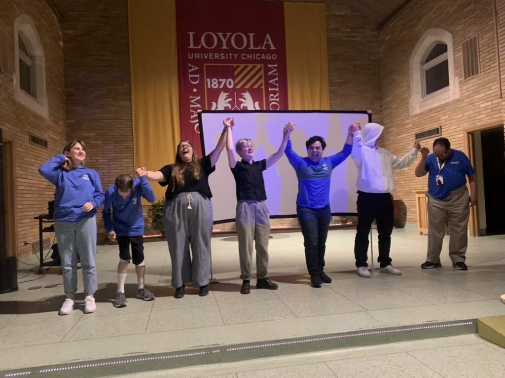 L'Arche fall retreat 2022 - volunteers and members perform on stage and take a bow