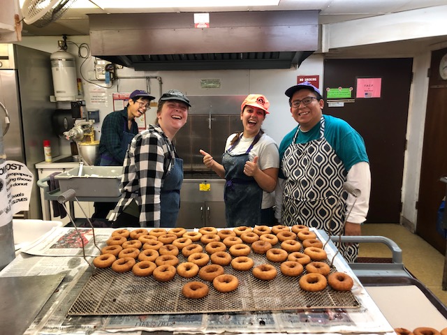 Volunteers and Members of L'Arche Chicago making doughnuts